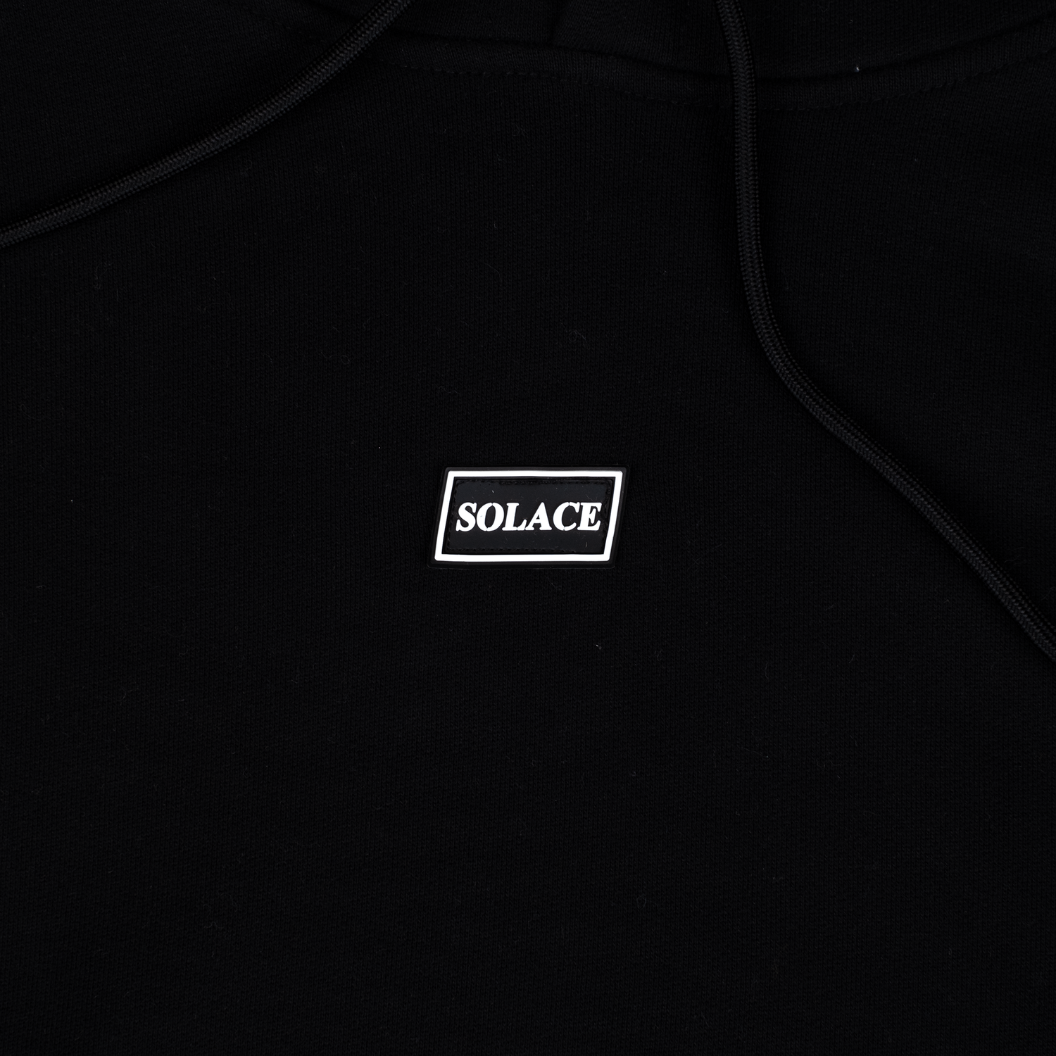 Solace Golf black hoody rubber box logo detail