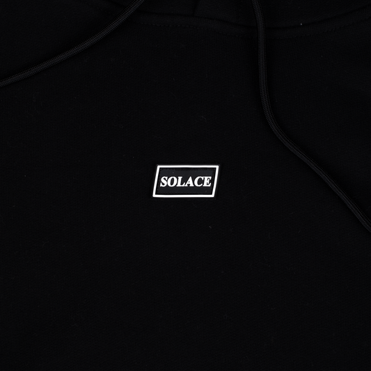 Solace Golf black hoody rubber box logo detail